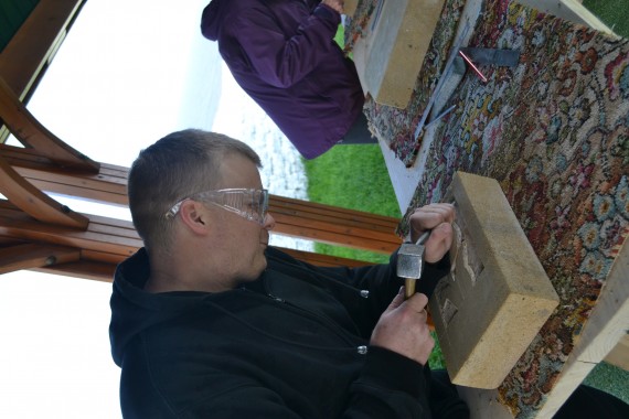 man using stone carving tools