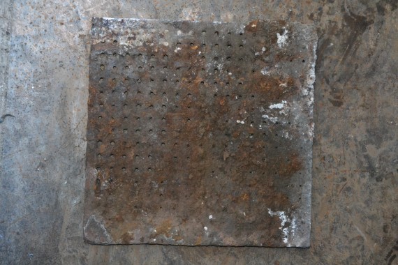 dimpled iron waffle tile kiln tile awaiting restoration