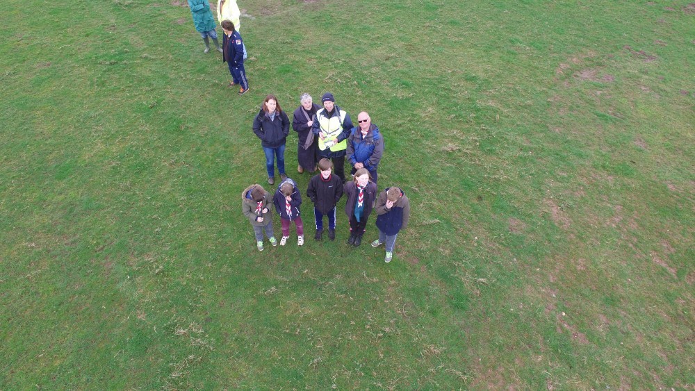 group watching drone