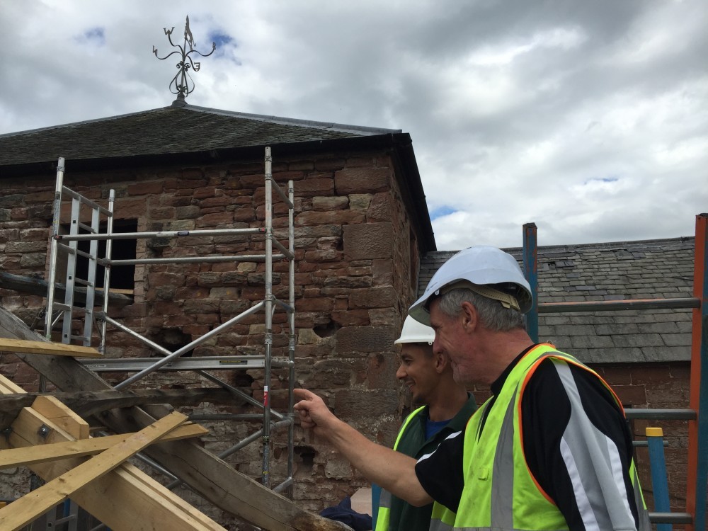 two men inspecting roof July 2016