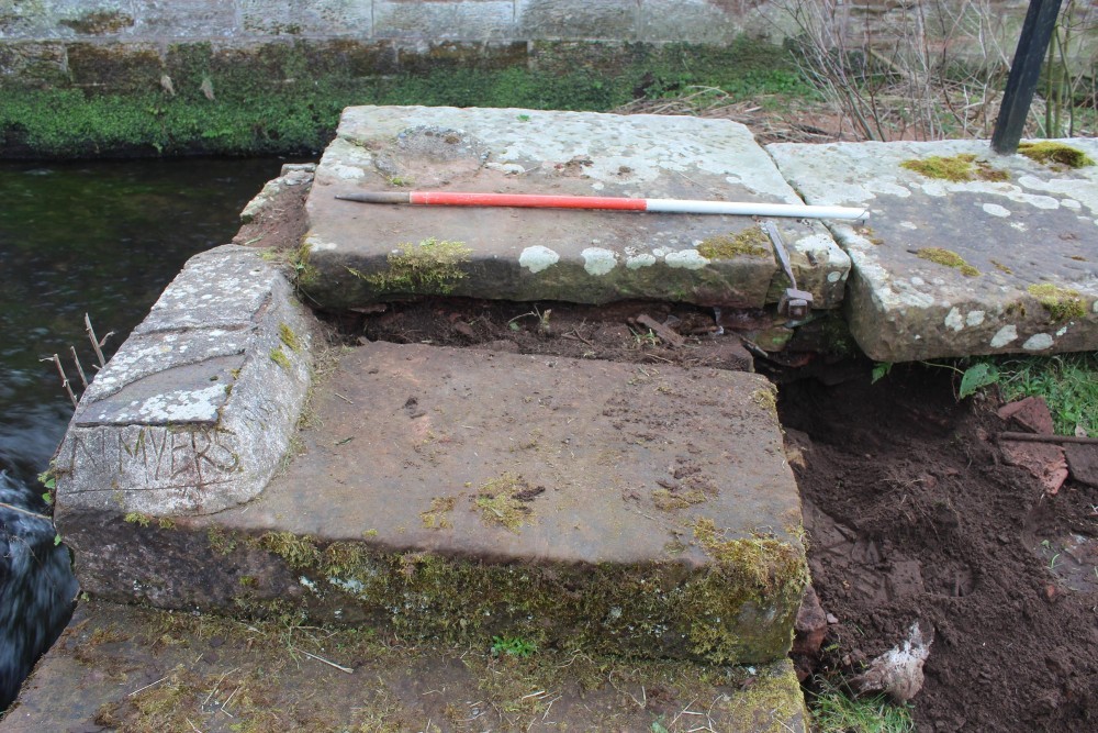 stone showing name and date scratch